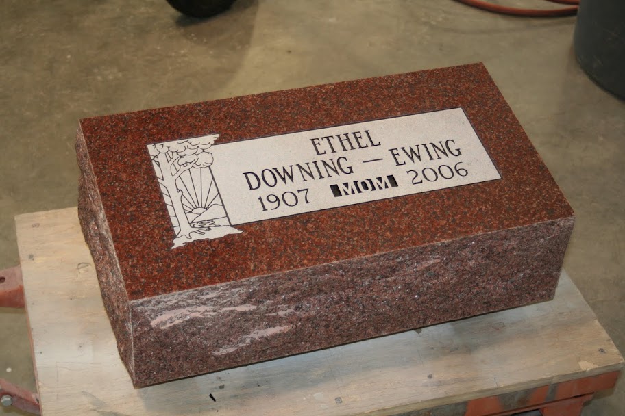 Pillow Grave Marker in Imperial red granite. White frosted panel with